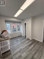 Unfurnished bedroom featuring dark wood-type flooring - 