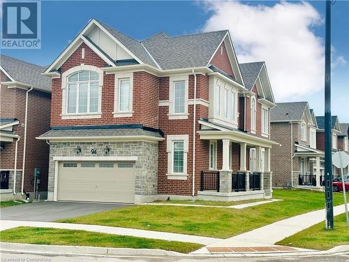 View of front of home featuring a front yard, a garage, and covered porch - 94 Milt Schmidt Street, Kitchener, ON - Outdoor With Facade