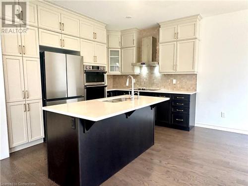 Kitchen featuring dark hardwood / wood-style flooring, stainless steel appliances, a kitchen island with sink, sink, and wall chimney range hood - 94 Milt Schmidt Street, Kitchener, ON - Indoor Photo Showing Kitchen With Upgraded Kitchen