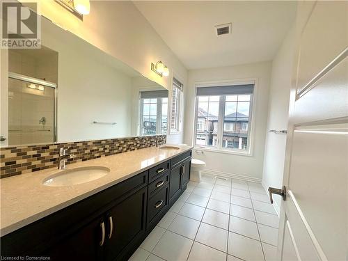 Bathroom with walk in shower, tile patterned flooring, toilet, decorative backsplash, and vanity - 94 Milt Schmidt Street, Kitchener, ON - Indoor Photo Showing Bathroom