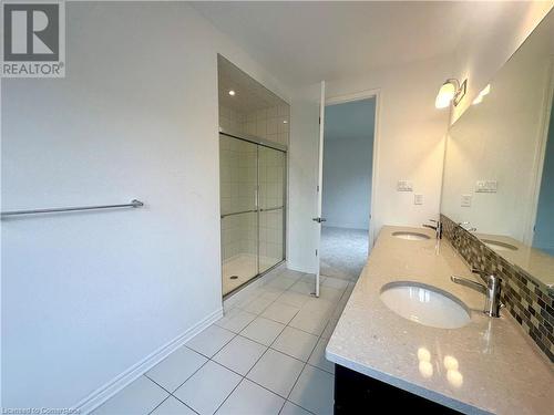 Bathroom featuring tile patterned flooring, vanity, and a shower with shower door - 94 Milt Schmidt Street, Kitchener, ON - Indoor Photo Showing Bathroom