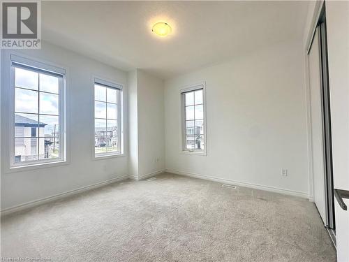 Spare room featuring light colored carpet - 94 Milt Schmidt Street, Kitchener, ON - Indoor Photo Showing Other Room