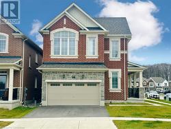 View of front of house with a front lawn and a garage - 