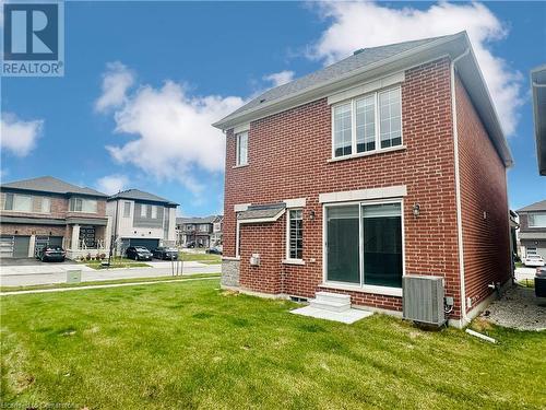 Rear view of property featuring a yard and cooling unit - 94 Milt Schmidt Street, Kitchener, ON - Outdoor