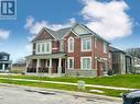 View of front facade featuring a porch, cooling unit, and a front lawn - 94 Milt Schmidt Street, Kitchener, ON  - Outdoor With Facade 