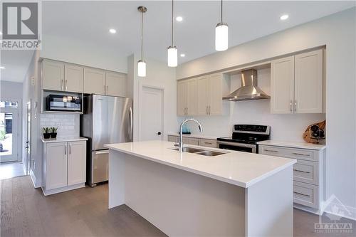 A Stunning Kitchen with Quartz Countertops and Stainless Steel Appliances - 721 Capricorn Circle, Ottawa, ON - Indoor Photo Showing Kitchen With Stainless Steel Kitchen With Double Sink With Upgraded Kitchen