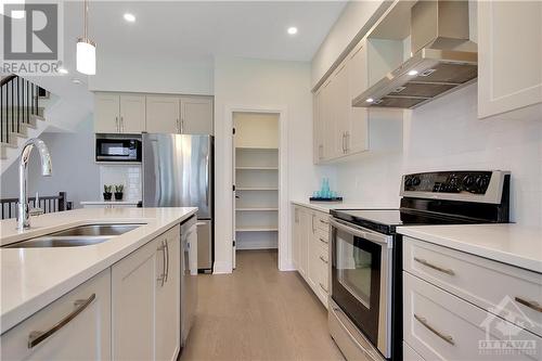 You’ll enjoy ample storage space in the Pantry and adequate cabinet space in this incredible Kitchen! - 721 Capricorn Circle, Ottawa, ON - Indoor Photo Showing Kitchen With Stainless Steel Kitchen With Double Sink With Upgraded Kitchen