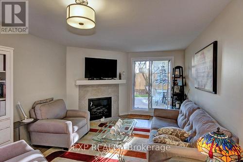 111 - 733 Deveron Crescent, London, ON - Indoor Photo Showing Living Room With Fireplace