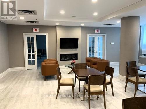 209 - 39 Oneida Crescent, Richmond Hill, ON - Indoor Photo Showing Dining Room With Fireplace