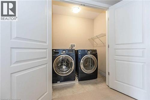 Clothes washing area with light tile patterned floors and washer and dryer - 243 Greenwater Place Unit# Upper, Kitchener, ON - Indoor Photo Showing Laundry Room