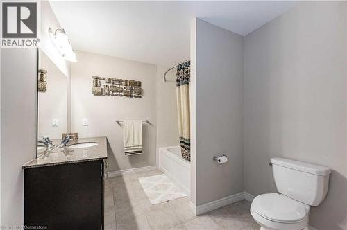 Full bathroom with toilet, tile patterned floors, vanity, and shower / tub combo with curtain - 243 Greenwater Place Unit# Upper, Kitchener, ON - Indoor Photo Showing Bathroom