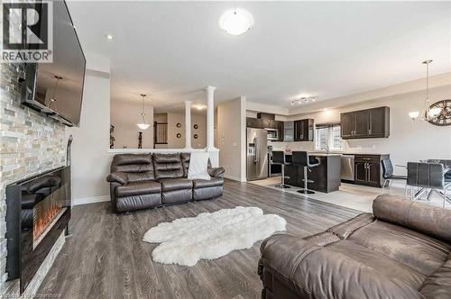 Living room featuring dark hardwood / wood-style floors and a chandelier - 243 Greenwater Place Unit# Upper, Kitchener, ON - Indoor Photo Showing Living Room With Fireplace