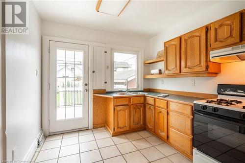 to Backyard - 53 Tuxedo Avenue S, Hamilton, ON - Indoor Photo Showing Kitchen With Double Sink