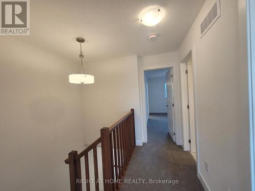 Hallway with modern railings and lights - 32 Overberg Way, Kanata (9010 - Kanata - Emerald Meadows/Trailwest), ON - Indoor Photo Showing Other Room