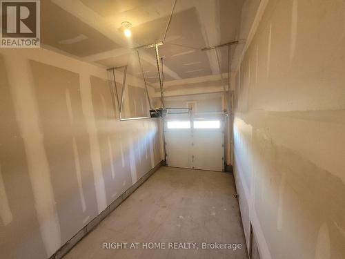 Garage with garage door opener - 32 Overberg Way, Kanata (9010 - Kanata - Emerald Meadows/Trailwest), ON - Indoor Photo Showing Garage