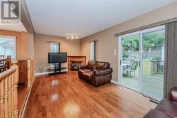 Living room featuring light hardwood / wood-style floors and a textured ceiling - 