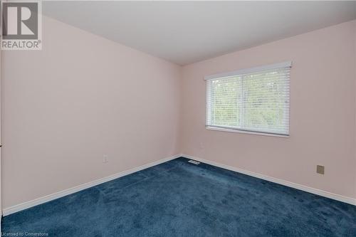 Unfurnished room featuring dark colored carpet - 435 Shadow Wood Crescent, Waterloo, ON - Indoor Photo Showing Other Room