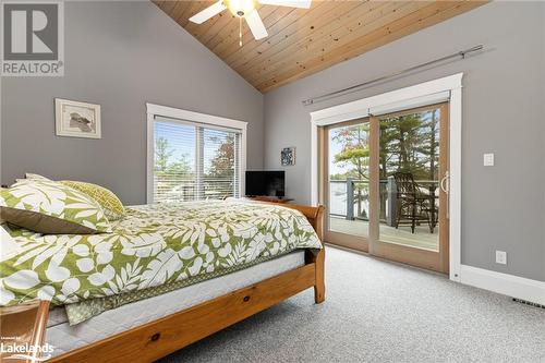 Bedroom with access to outside, multiple windows, ceiling fan, and wood ceiling - 3298 Seydel Lane Lane, Coldwater, ON - Indoor Photo Showing Bedroom