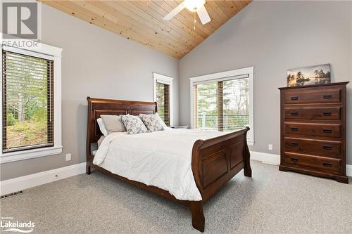 Bedroom featuring ceiling fan, high vaulted ceiling, wood ceiling, and light carpet - 3298 Seydel Lane Lane, Coldwater, ON - Indoor Photo Showing Bedroom