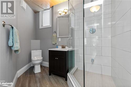 Bathroom with walk in shower, wood ceiling, vanity, hardwood / wood-style flooring, and toilet - 3298 Seydel Lane Lane, Coldwater, ON - Indoor Photo Showing Bathroom