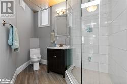 Bathroom with walk in shower, wood ceiling, vanity, hardwood / wood-style flooring, and toilet - 