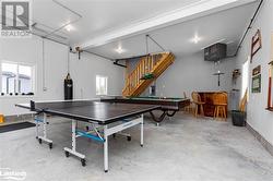 Rec room featuring concrete floors, pool table, and water heater - 