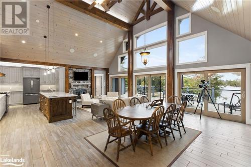 Dining space with beam ceiling, sink, high vaulted ceiling, and light hardwood / wood-style flooring - 3298 Seydel Lane Lane, Coldwater, ON - Indoor Photo Showing Dining Room