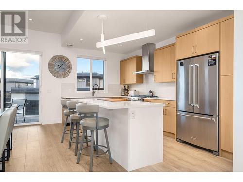 kitchen view to balcony - 105 Predator Ridge Drive Unit# 3, Vernon, BC - Indoor Photo Showing Kitchen With Upgraded Kitchen