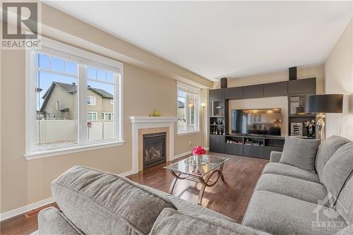 Large Great Room with Cozy Gas Fireplace - 379 Andalusian Crescent, Kanata (9010 - Kanata - Emerald Meadows/Trailwest), ON - Indoor Photo Showing Living Room With Fireplace