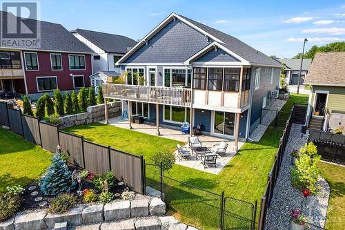 Upper deck and lower patio overlooks fenced yard that backs onto parkette with pond and walkway. - 11 New Haven Gate, Westport, ON - Outdoor With Deck Patio Veranda