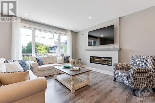 Living room electric fireplace with touch screen and colour light flames. - 11 New Haven Gate, Westport, ON - Indoor Photo Showing Living Room With Fireplace