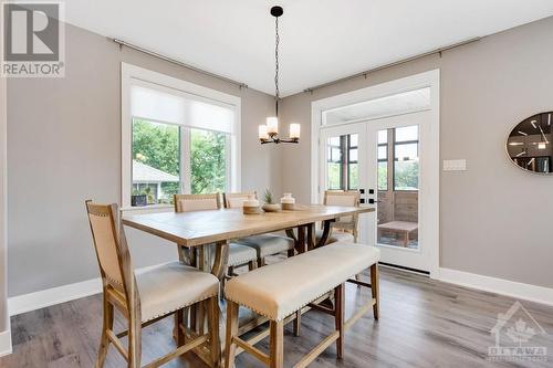 Dining area garden door opens to three-season sunroom - 11 New Haven Gate, Westport, ON - Indoor Photo Showing Dining Room