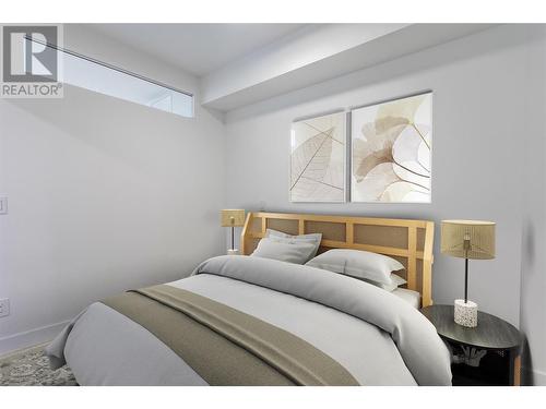 This photo has been virtually staged. - 1488 Bertram Street Unit# 1101, Kelowna, BC - Indoor Photo Showing Bedroom