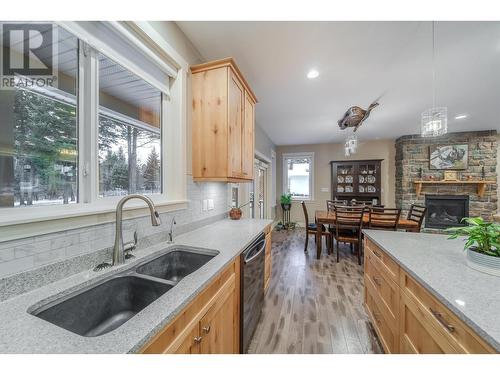 4889 Canium Court, 108 Mile Ranch, BC - Indoor Photo Showing Kitchen With Fireplace With Double Sink