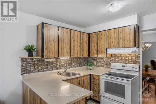 NOTE: Designer glass tile backsplash -- an expensive upgrade!  Fridge, stove, & hood fan are included. - 840 Cahill Drive W Unit#20, Ottawa, ON - Indoor Photo Showing Kitchen