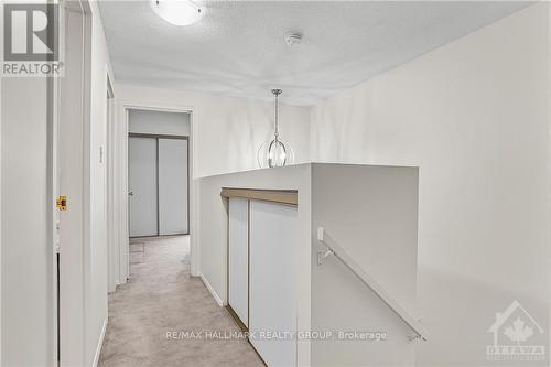 The upper HALLWAY has a spacious LINEN CLOSET and stunning new light fixture! - 840 Cahill Drive W Unit#20, Ottawa, ON -  Photo Showing Other Room