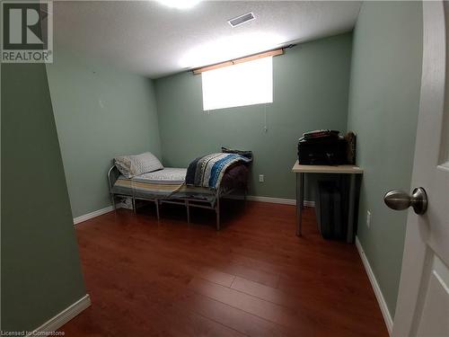 Bedroom featuring dark hardwood / wood-style floors and a textured ceiling - 12 Peer Drive Unit# Basement, Guelph, ON - Indoor Photo Showing Other Room