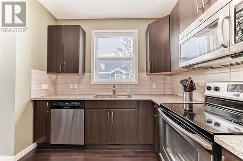 703, 10 Auburn Bay Avenue Se, Calgary, AB - Indoor Photo Showing Kitchen With Double Sink