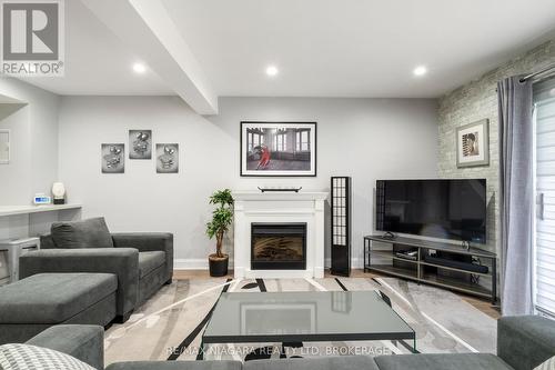 104 - 77 Linwell Road, St. Catharines (443 - Lakeport), ON - Indoor Photo Showing Living Room With Fireplace