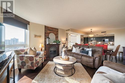 704 - 700 Wilson Road N, Oshawa (Centennial), ON - Indoor Photo Showing Living Room With Fireplace