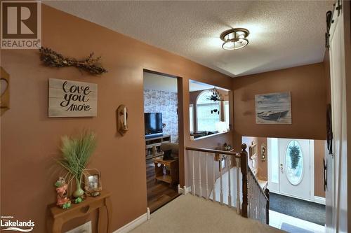 Hall with carpet floors and a textured ceiling - 97 Glen Eton Road, Wasaga Beach, ON 