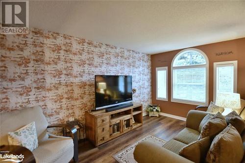 Living room featuring dark hardwood / wood-style floors - 97 Glen Eton Road, Wasaga Beach, ON 