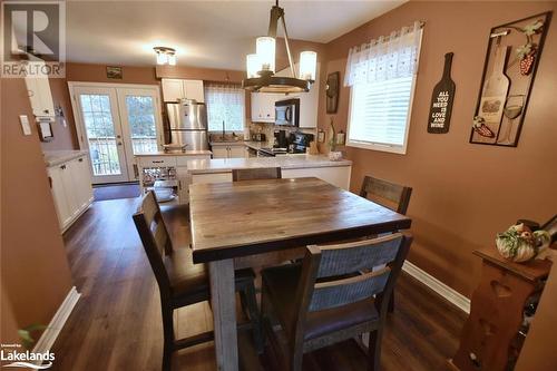 Dining area with a wealth of natural light, french doors, dark hardwood / wood-style floors, and sink - 97 Glen Eton Road, Wasaga Beach, ON 