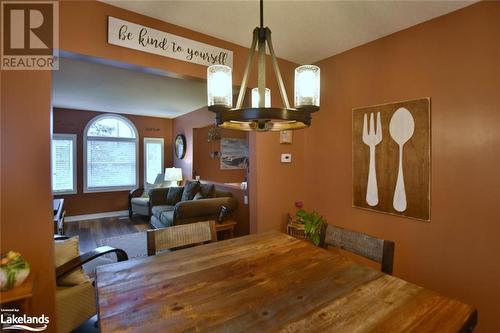 Dining area featuring a chandelier and hardwood / wood-style flooring - 97 Glen Eton Road, Wasaga Beach, ON 