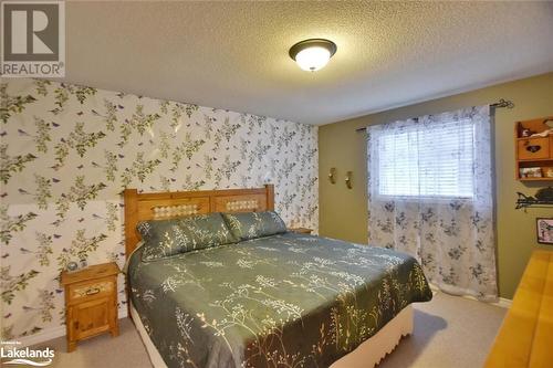 Carpeted bedroom featuring a textured ceiling - 97 Glen Eton Road, Wasaga Beach, ON 