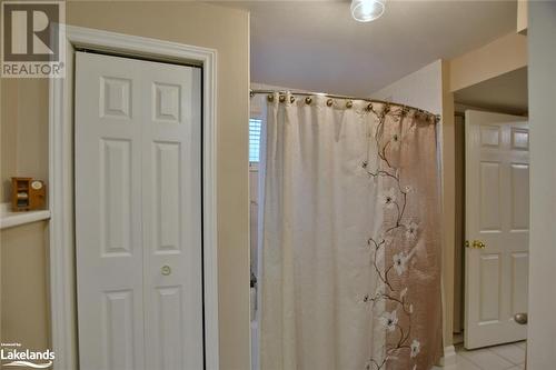 Bathroom featuring tile patterned floors and curtained shower - 97 Glen Eton Road, Wasaga Beach, ON 