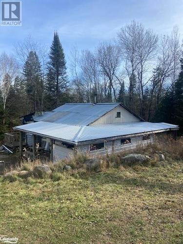 View of side of home featuring a lawn - 2828 Fire Route 72 Route, North Kawartha Twp, ON 