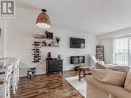 204 - 90 Aspen Springs Drive W, Clarington, ON - Indoor Photo Showing Living Room With Fireplace