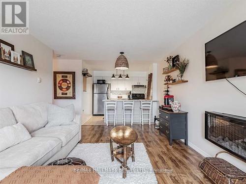 204 - 90 Aspen Springs Drive W, Clarington, ON - Indoor Photo Showing Living Room With Fireplace