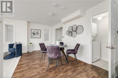 Dining space featuring hardwood / wood-style flooring and stacked washer / dryer - 577 Goldenrod Lane, Kitchener, ON - Indoor Photo Showing Dining Room